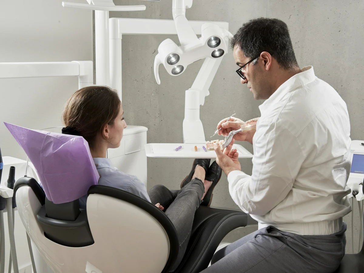 A patient speaks with a dentist before treatment